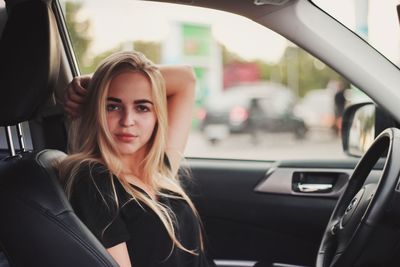 Portrait of young woman in car