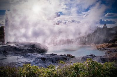 Scenic view of geyser against sky