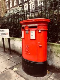 Red mailbox on city