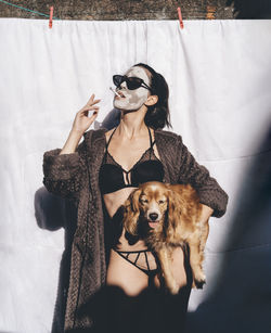 Woman smoking holding a dog