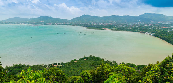 Scenic view of sea and mountains against sky