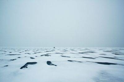 Scenic view of sea against clear sky during winter