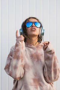 Dreadlock woman listening to music in headphones.