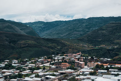 High angle view of townscape and mountains against sky