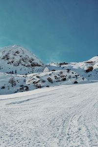 Snow covered mountain against blue sky