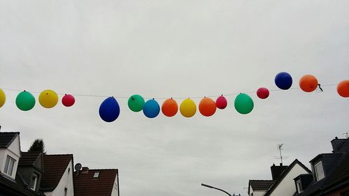 Low angle view of balloons flying in sky