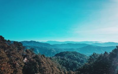 Scenic view of mountains against blue sky