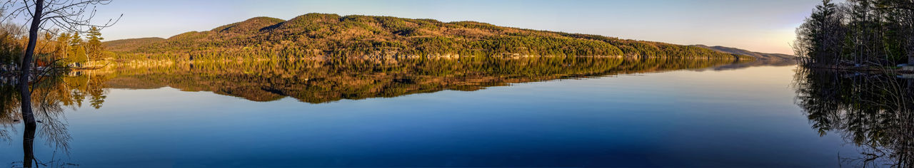 Reflection of trees in lake against sky