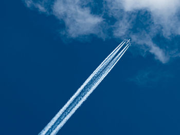 Low angle view of airplane flying against sky