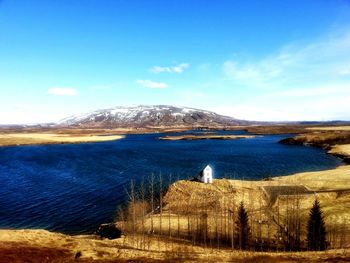 Scenic view of lake against cloudy sky