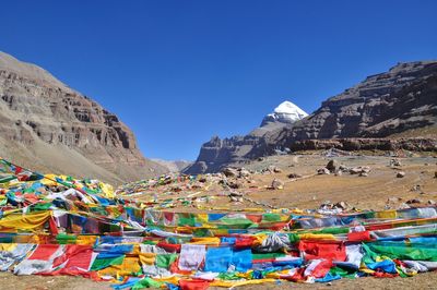 View of multi colored houses on mountain against sky