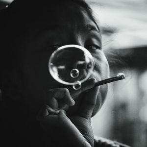 Close-up portrait of woman blowing bubble