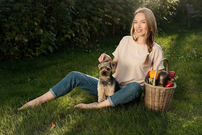Woman with dog sitting in basket
