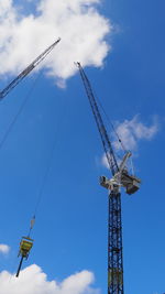 Low angle view of crane against sky