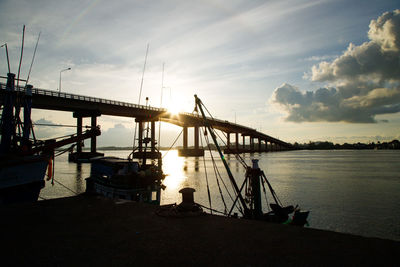 Silhouette view of harbor at the sunrise and the bridge at taksin bridge,chanthaburi, thailand 