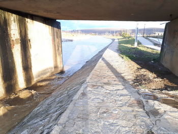 Walkway in water against sky