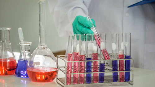 Midsection of scientist doing experiment at laboratory