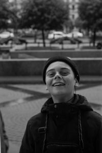 Portrait of smiling boy in city