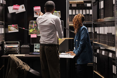 Rear view of people working in cafe