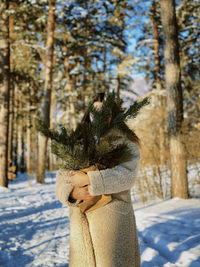 Rear view of woman standing in snow