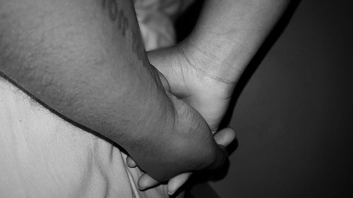 Cropped image of father holding child hand