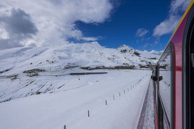 Panoramic view of ski lift against cloudy sky