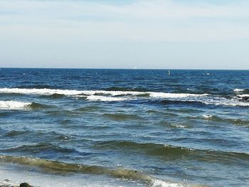 Scenic view of sea against blue sky