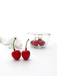 Close-up of tomatoes on table against white background