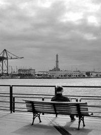 River in city against cloudy sky