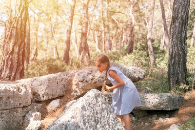 Kid girl traveler of eight years old travel and explore the ancient excavations of ruins