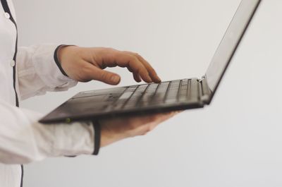 Midsection of man using mobile phone