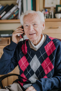 Portrait of smiling man sitting at home