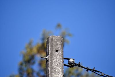 Low angle view of metallic structure against clear blue sky