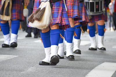 Low section of people walking on street