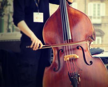 Midsection of woman playing cello