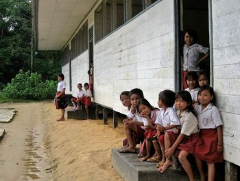 Group of people sitting in front of building