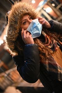 Portrait of young woman drinking water