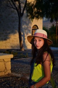 Portrait of beautiful young woman standing outdoors