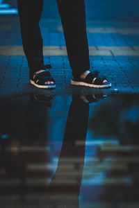 Low section of man standing on footpath