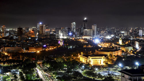 Aerial view of city lit up at night