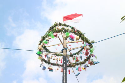 Low angle view of christmas decorations hanging against sky