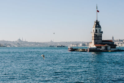 Sailboats in sea against clear sky