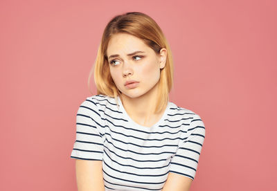 Portrait of a beautiful young woman over red background