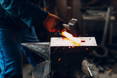 Midsection of man working in workshop