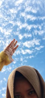 Low angle view of senior woman against sky