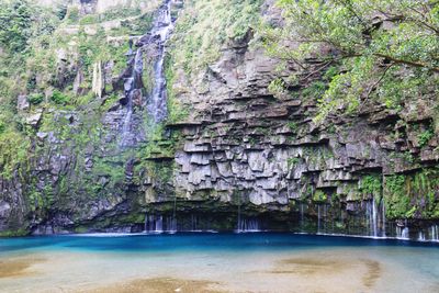 Scenic view of waterfall against rock formation