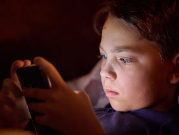 Portrait of boy using mobile phone