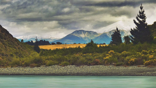 Scenic view of mountains against cloudy sky