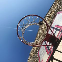 Low angle view of basketball hoop against blue sky
