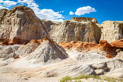 Rock formations on landscape against cloudy sky